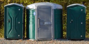 ada porta potty in a gravel lot